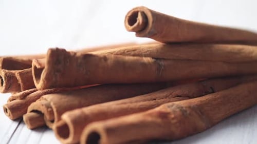 Slow Motion of Cinnamon Sticks Drops on Table