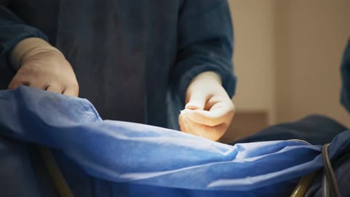 Surgeon Hands Suture With Surgical Tools During Operation