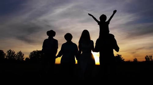 Three Generation Family Walking at Bright Sunset