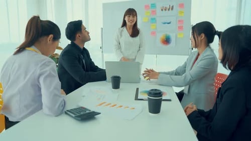 Team Celebrates Success After Presentation in Office