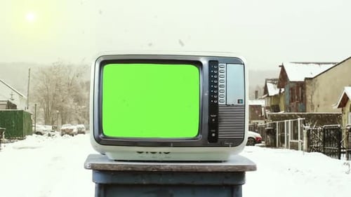 Old TV Green Screen on Street in the Snow.