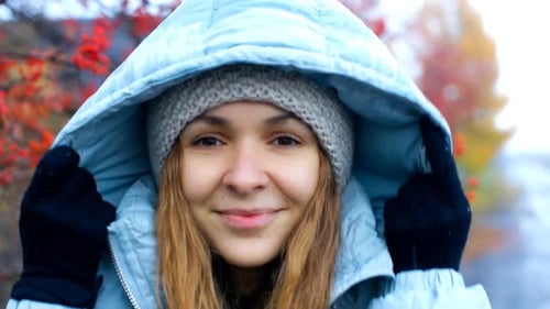 Young Woman Poses Putting on Hood at Rowan Tree Red Berries