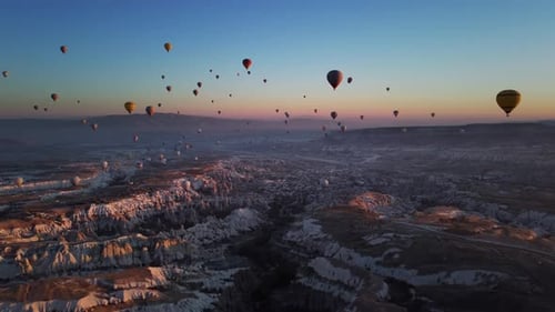 Idyllic Scenery of Cappadocia Valley and Lots of Flying Hot Air Balloons Over Volcanic Hills