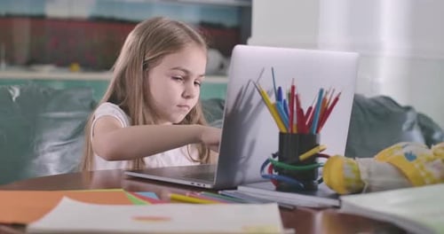 Concentrated Caucasian Girl Typing on Laptop Keyboard. Education, E-learning, Online Messaging