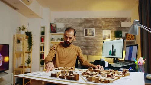 Architect Working on City Model in Modern Office