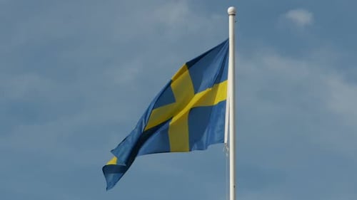 Sweden Flag Waving Proudly Against Blue Sky
