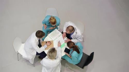 Medical Professionals Collaborating Around Table in Hospital