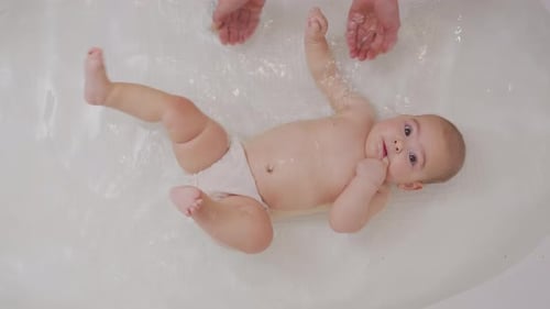 Baby Close Up Playing in Bath