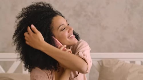 Woman Chatting Cheerfully on Mobile Phone Indoors