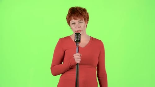 Woman Singing into Vintage Microphone on Green Screen