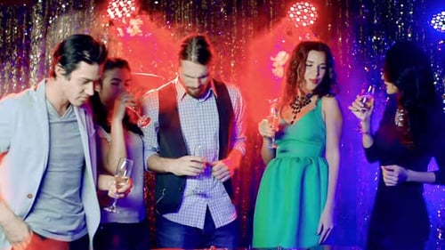 Friends Celebrating With Champagne in Nightclub