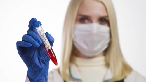 Medical Professional Holding Positive COVID-19 Blood Sample