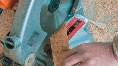Carpenter Using Circular Saw for Cutting Wooden Boards
