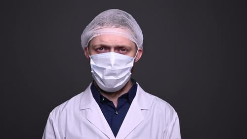 A male doctor takes off a medical mask. End of covid-19 coronavirus epidemic