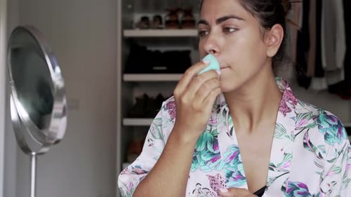 Woman Applies Makeup at Home in Daylight