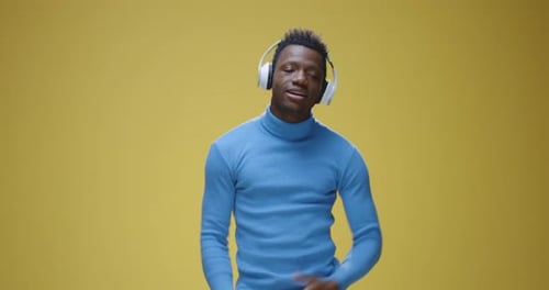 Young Adult Dances to Music on Headphones