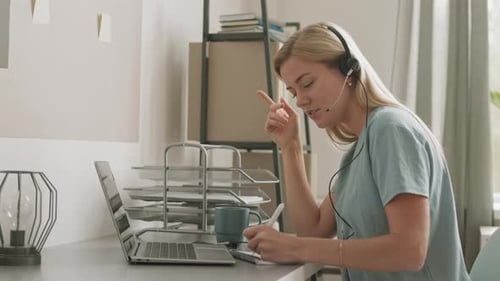 Woman in Home Office Attending Virtual Meeting