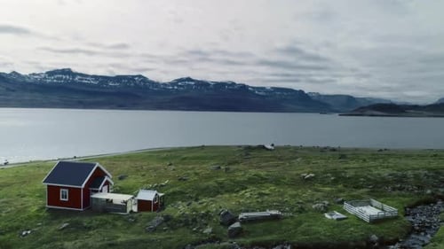 Small Red House on Fjord Landscape in Scandinavia