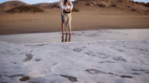 Bonding Young Couple Standing on Sandy Beach Shoreline Watch Sunset Waves From the Ocean