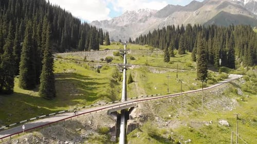 Man Ride Bicycle on the Mountain Road Top View