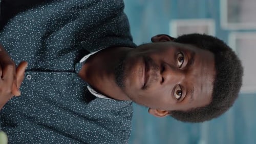 Young Man Talking and Drinking Coffee on Video Call