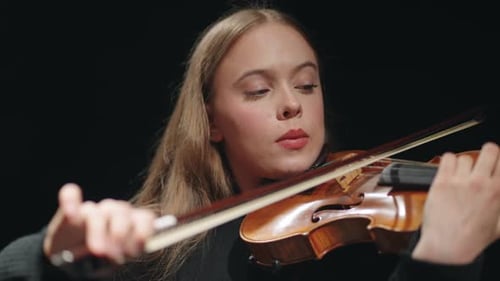 Pretty Young Female Fiddler is Playing Violin or Viola in Philharmonic Hall Portrait