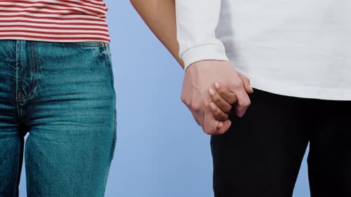 Two People Holding Hands in Loving Embrace