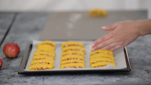 Preparing Uncooked Apple Pastry on Baking Sheet