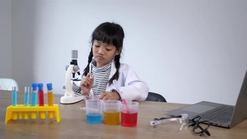 Young Girl Conducting Scientific Experiment with Microscope