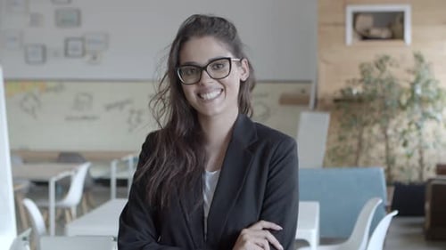 Confident Businesswoman Smiling in Office Environment