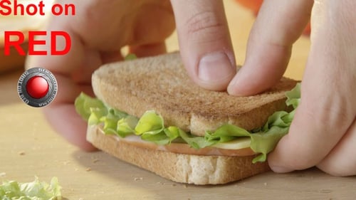 Sandwich being Prepared with Ham, Cheese and Lettuce