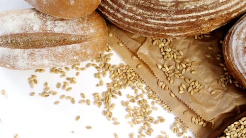 Fresh Bread, Wheat, and Wooden Spoon Overhead