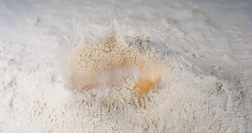 Eggs Falling on Flour, Slow Motion 4K