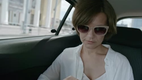 Woman Riding on Backseat and Using Smartphone
