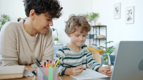 Adult Helps Child with Schoolwork at Home