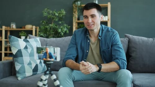 Man Records Video Blog on Smartphone at Home