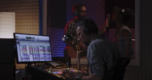 Vocalist Guitarist and Sound Engineer Working in Studio