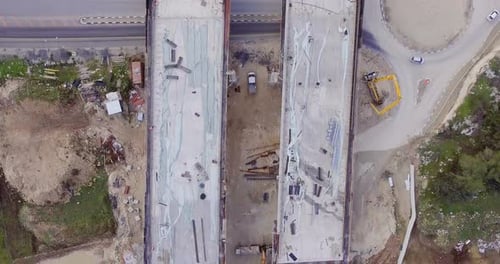 Aerial footage of a large scale highway construction project with tunnels and bridges
