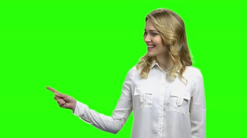 Smiling Woman Pointing on Green Screen Background