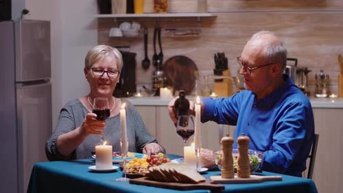 Mature Couple Enjoying Romantic Candlelit Dinner at Home