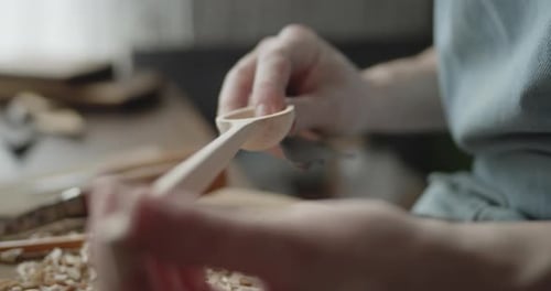 Young Woman Carpenter Examines Handmade Wooden Spoon Extreme Close-up
