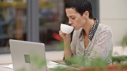 Businesswoman Working in the Street Cafe