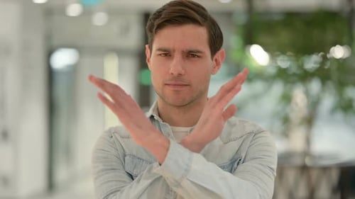 Portrait of No Sign By Creative Young Man By Arms Gesture