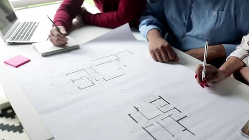 Group of Architects Discussing Building Project