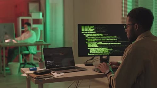 Men Programming Code Late at Night in Office