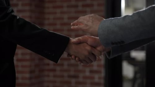 Businessmen Handshake Close Up in Office Setting