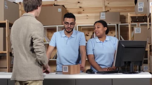 Customer Interacts with Shipping Employees at the Counter