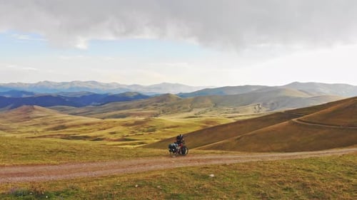 Solo Cyclist Touring Mountainous Rural Landscape
