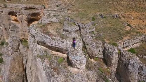 Girl Standing On Edge Of Cliff
