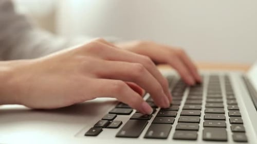 Woman Using on Notebook Computer at Home